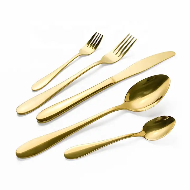 Gold flat-handled cutlery set including a teaspoon, dinner spoon, salad fork, dinner fork, and dinner knife