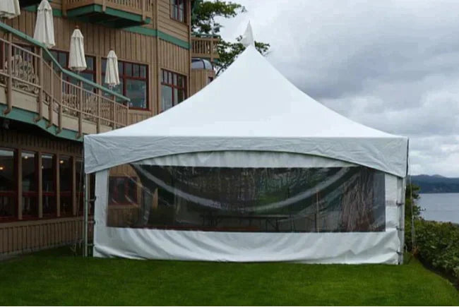 a cafe window wall affixed to a high peak marquee tent